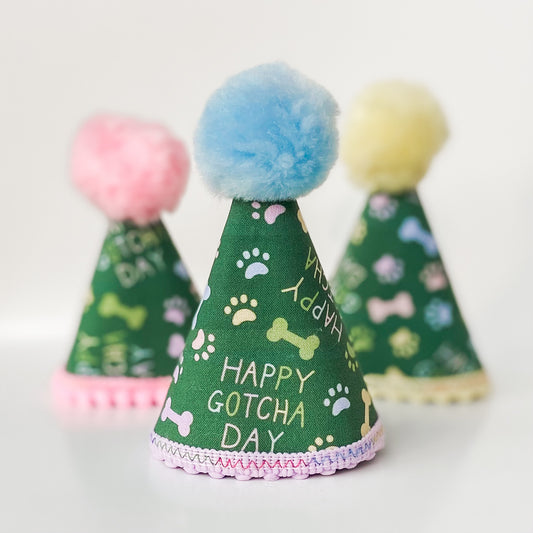 Happy Gotcha Day! dog party hat with paws and bones dog birthday accessory