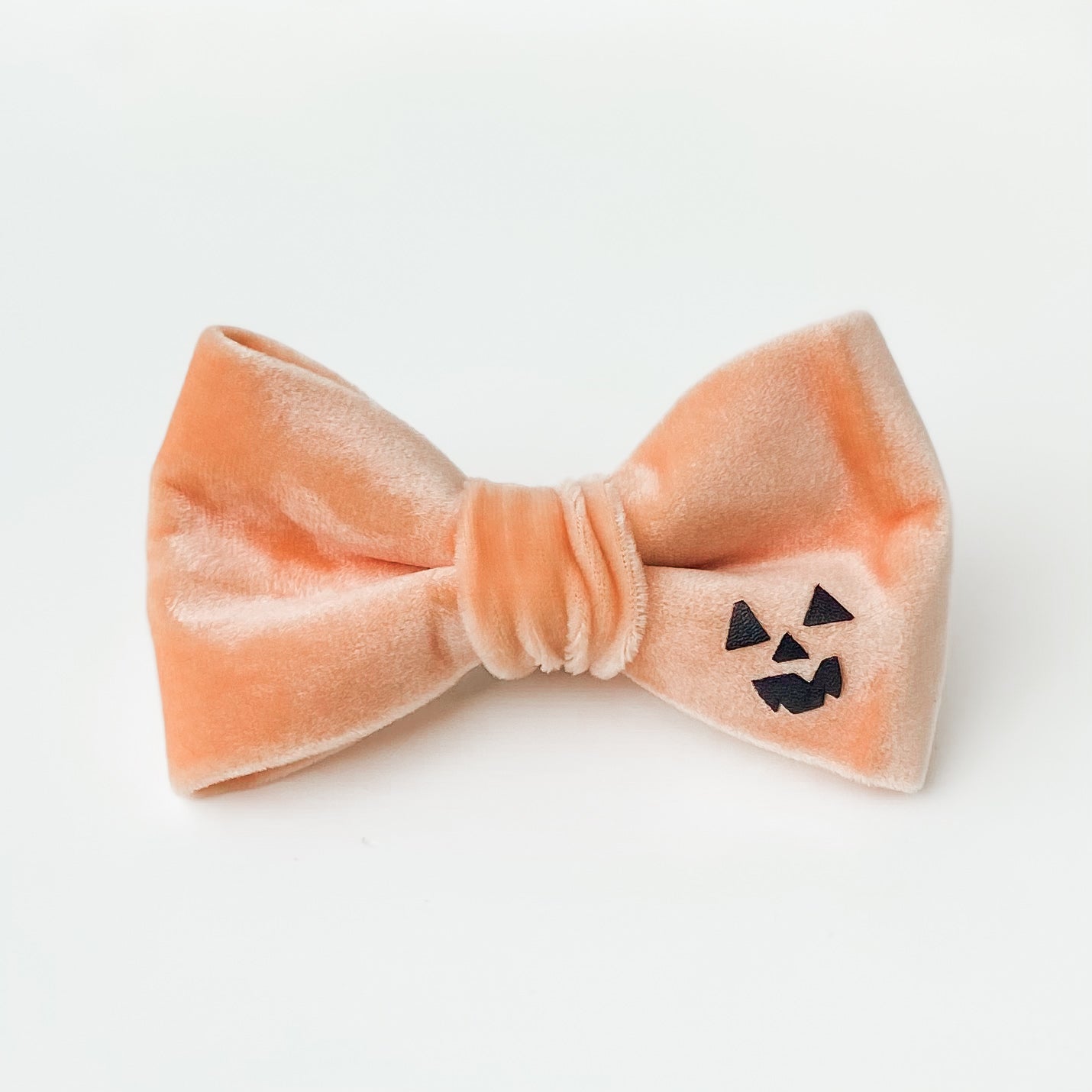 Peach spooky pumpkin face Halloween dog bow accessory
