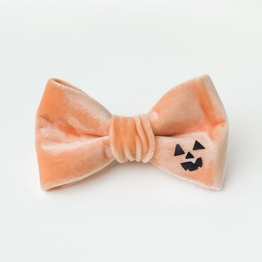 Peach spooky pumpkin face Halloween dog bow accessory
